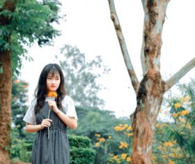 Girl holding a flower in hand Stock Photo
