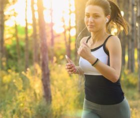 Girl listening to music running Stock Photo