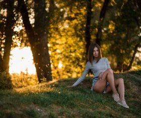 Girl sitting in the woods taking pictures Stock Photo