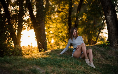 Girl sitting in the woods taking pictures Stock Photo