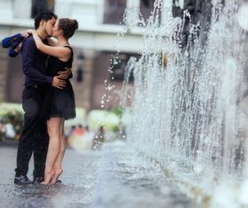 Kissing couple by the fountain Stock Photo