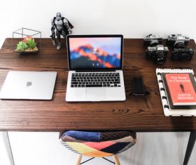 Laptop and camera on the table Stock Photo