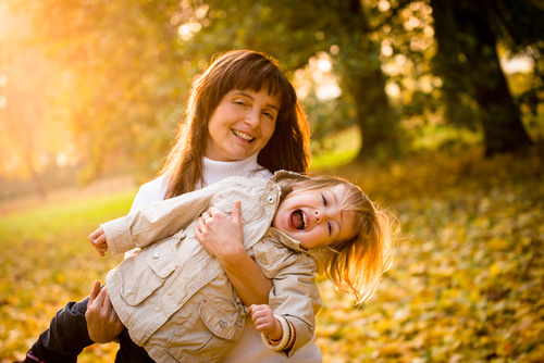 Little child and grandmother playing in the park Stock Photo