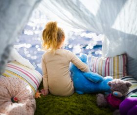 Little girl holding teddy bear Stock Photo