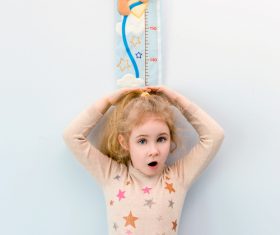 Little girl measuring height Stock Photo