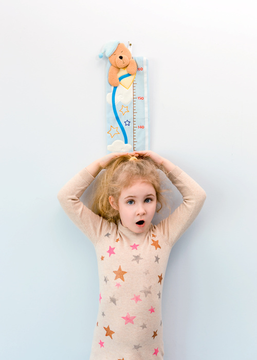 Little girl measuring height Stock Photo