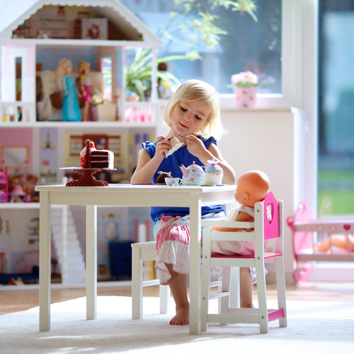 Little girl playing mini doll house at home Stock Photo 02