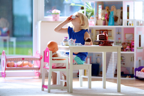 Little girl playing mini doll house at home Stock Photo 04