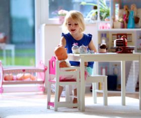 Little girl playing mini doll house at home Stock Photo 05