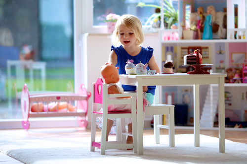 Little girl playing mini doll house at home Stock Photo 05