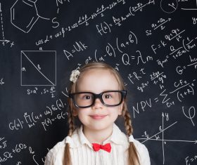 Little girl standing in front of the blackboard Stock Photo 09
