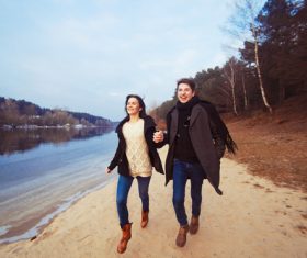 Lovers running hand in hand Stock Photo