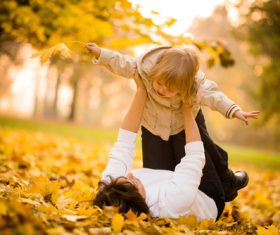 Lying on the ground and playing with the kid Stock Photo 01