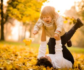 Lying on the ground and playing with the kid Stock Photo 02