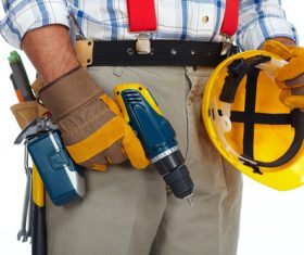Maintenance worker holding electric drill Stock Photo