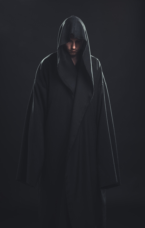Man wearing black cloak Stock Photo