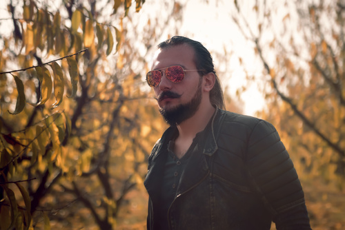 Man with sunglasses leaving beard Stock Photo