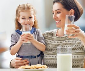 Mother and daughter drinking milk together Stock Photo
