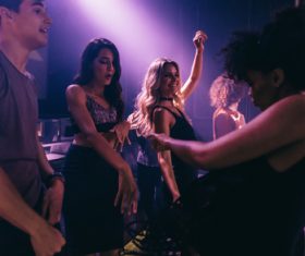 Nightclub dancing men and women Stock Photo