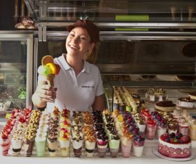 Smiling saleswoman selling ice cream Stock Photo