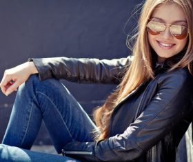 Smiling woman sitting on the ground Stock Photo