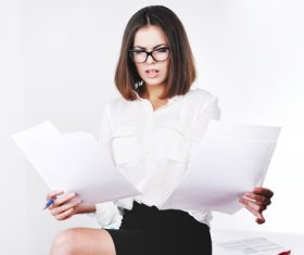 Stock Photo Businesswoman looking at market data files 10
