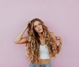 Stock Photo Cute blond girl in front of pink background