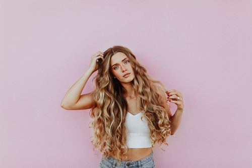 Stock Photo Cute blond girl in front of pink background