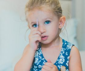 Stock Photo Cute little girl holding a hair clip