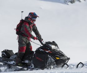 Stock Photo Man driving a snowmobile