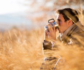 Stock Photo Man sitting outdoors drinking coffee