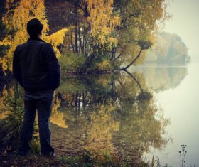 Stock Photo Man standing by the river