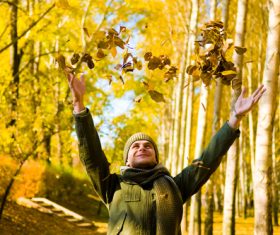 Stock Photo Man throwing fallen leaves in autumn 01