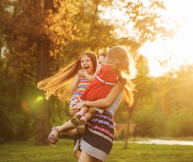 Stock Photo Mother holding two daughters