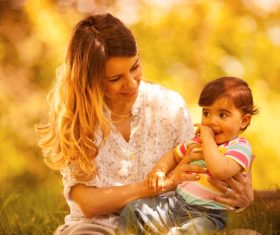 Stock Photo Mother playing with baby outdoors