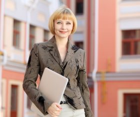 Stock Photo Smiling woman holding laptop