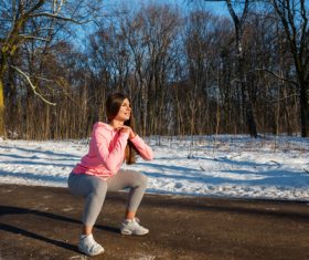 Stock Photo Winter outdoor squat sport girl