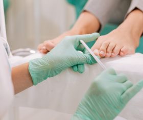 Stock Photo Woman doing foot care