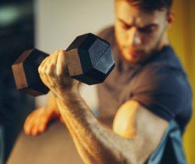 Stock Photo Young male doing biceps exercise with dumbbells 01