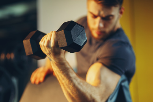 Stock Photo Young male doing biceps exercise with dumbbells 01