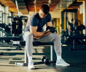 Stock Photo Young male doing biceps exercise with dumbbells 03