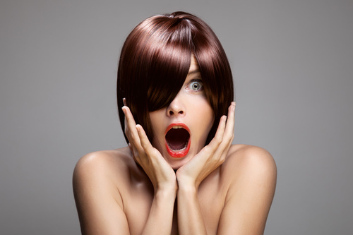 Surprised open mouth red hair woman Stock Photo