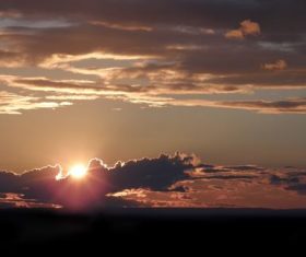 The sunset behind the clouds Stock Photo