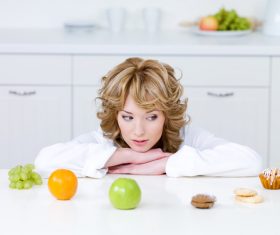 Woman choosing what to eat Stock Photo