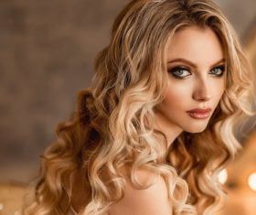 Woman golden big wavy curly hair Stock Photo