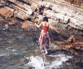 Woman playing with water by the river outdoors Stock Photo