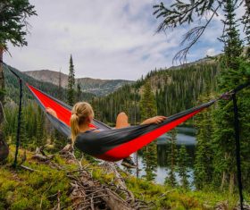 Woman sitting in hammock admiring the natural scenery Stock Photo