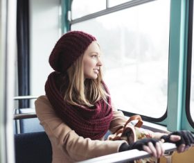 Woman sitting in the tram looks out the window Stock Photo