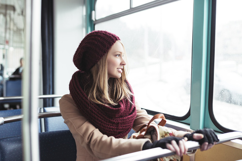 Woman sitting in the tram looks out the window Stock Photo