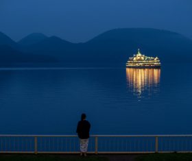 Woman standing on the bridge in the evening Stock Photo